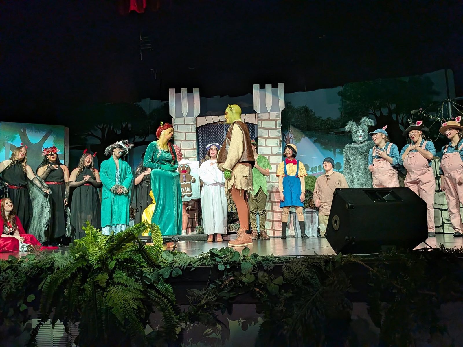 Full cast on stage in front of the castle set